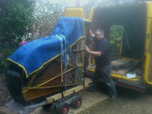 A 6ft grand piano being unloaded from the van. A 6ft grand piano being unloaded from the van by SW Piano Movers.
