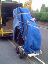 Loading a baby grand piano onto a van. SW Piano Movers loading a baby grand piano onto a van.