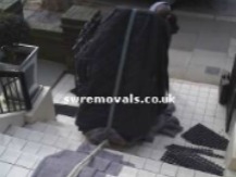 Sliding an upright piano up some very long steps. SW Piano movers slide an upright piano up some very long steps.